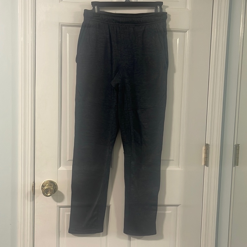 Men’s size S polyester athletic pants. Side pockets and zipper at ankles.